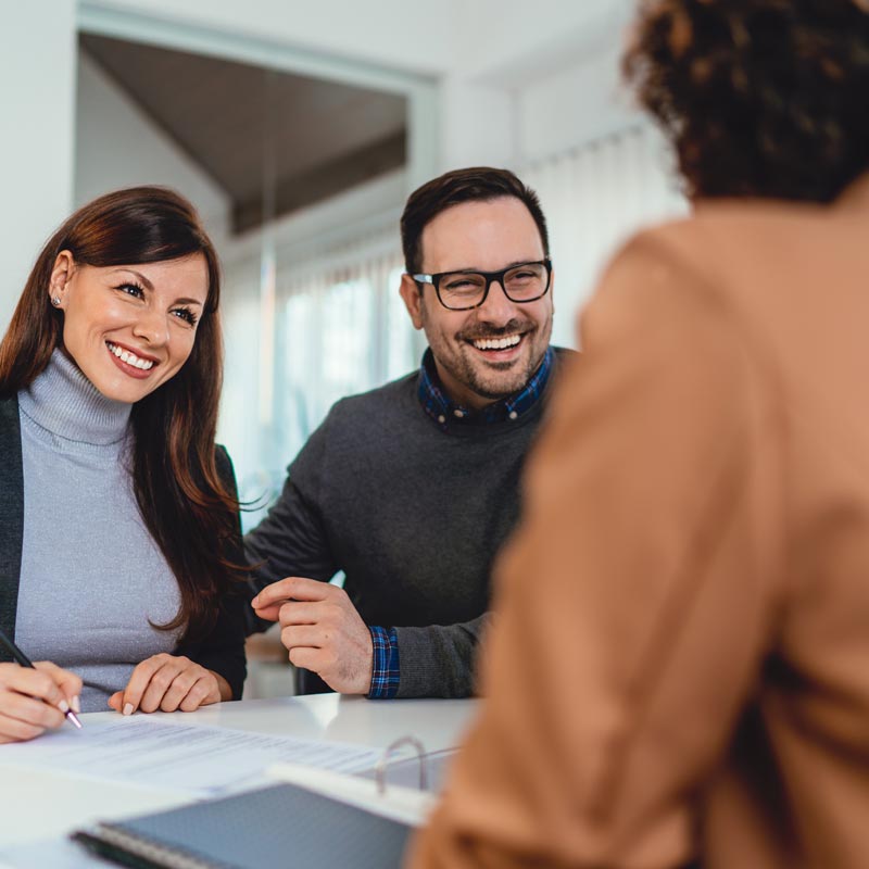 Couple signing loan agreement at the bank