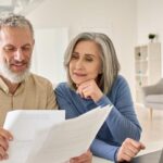 Older couple discussing mortgage contracts
