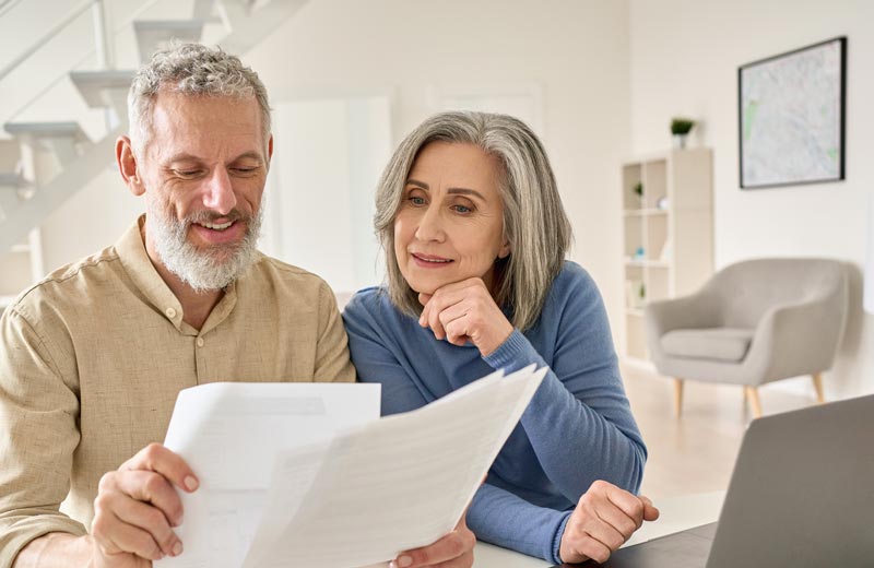 Older couple discussing mortgage contracts