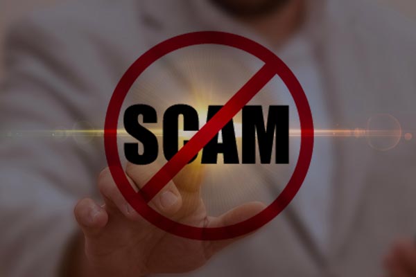 AdobeStock_536004262_Preview Businessman touching a glowing "No Scam" symbol with a prohibition sign