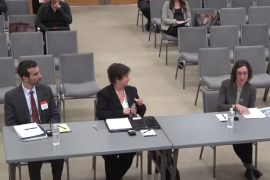 meeting-suzanne A few people sit at tables in a meeting