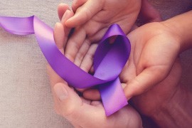 ribbonHands Purple ribbon on two hands.