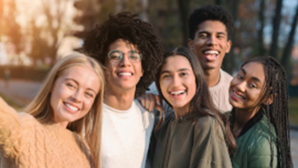 Young people stand together and laugh