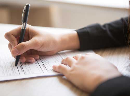 Hand holding a pen