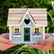 two hands holding a house model