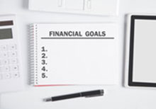 a note book with Financial plan on it