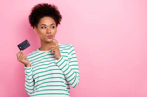 A girl holds a banking card